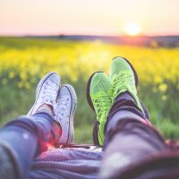 Young Couple Relaxing Enjoying Sunset From The Car